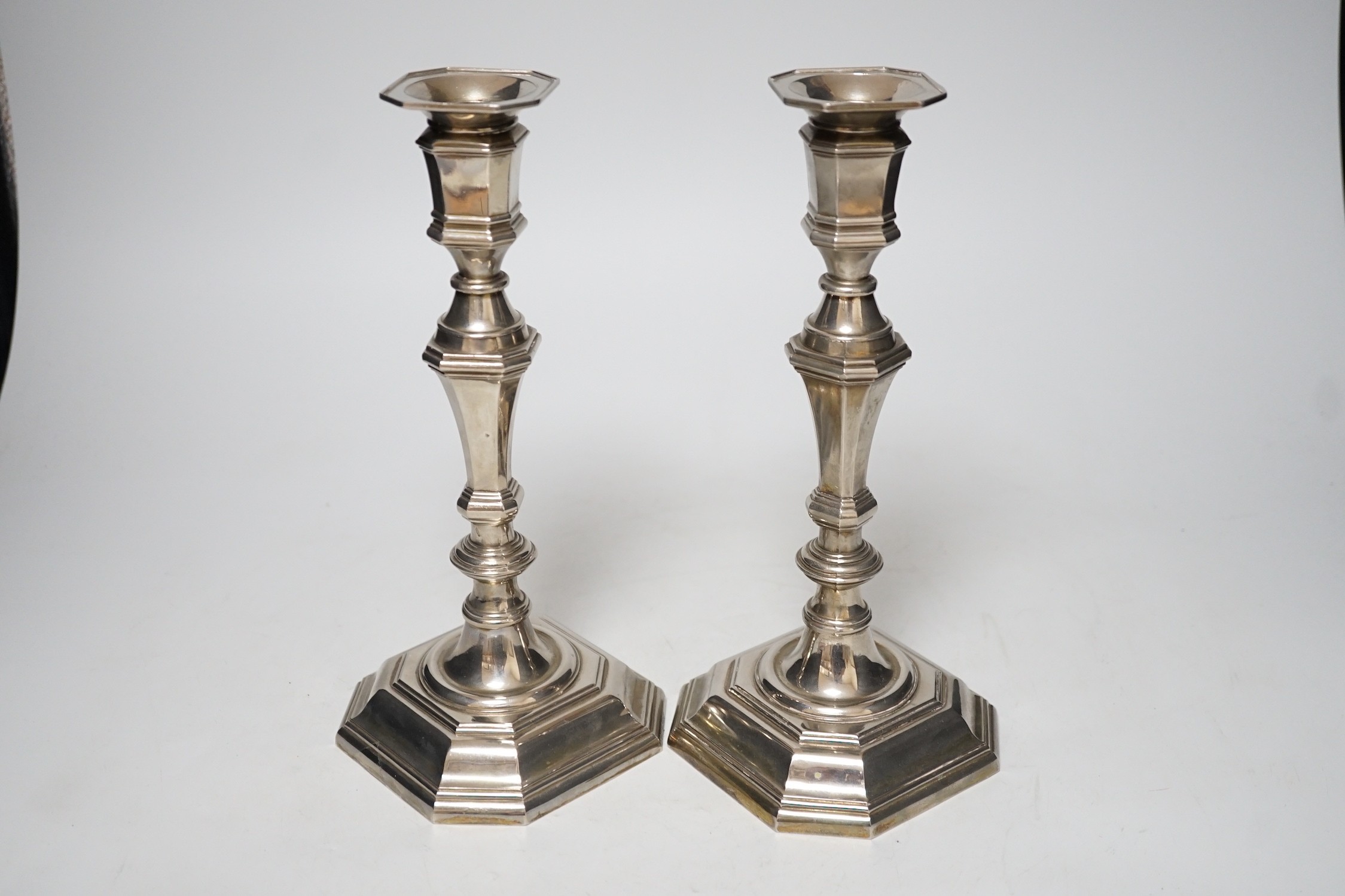 A pair of 18th century style plated octagonal candlesticks, 24.5cm.